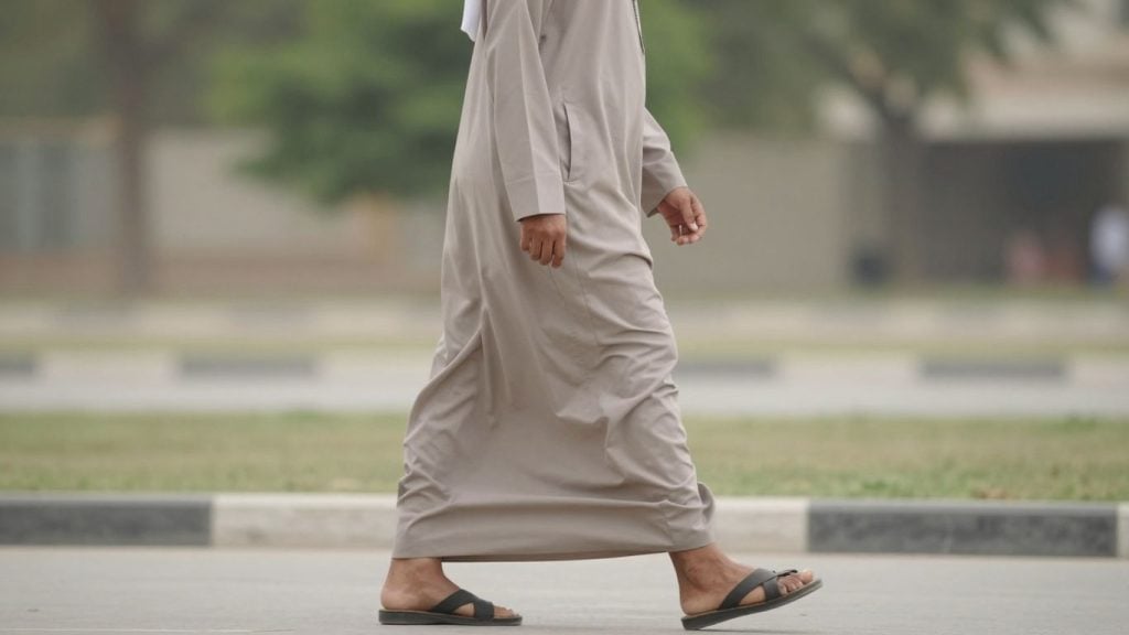 Person practicing Feldenkrais walking exercises with slow, mindful steps for better posture and coordination