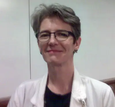 Jeanine, smiling, in a lab coat